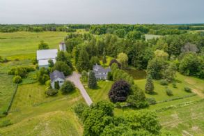 Aerial of house, coach house, barn, pond and woodlands with trails - Country homes for sale and luxury real estate including horse farms and property in the Caledon and King City areas near Toronto