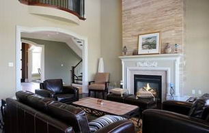 The Great Room - A dramatic 2-storey room with a custom beamed and coffered ceiling with architectural detailing. The room looks to the west and has a direct walk-out to the covered porch. The Great Room is anchored by an impressive 2-storey limestone fireplace with wood mantel and inlaid tile surround.  - Country homes for sale and luxury real estate including horse farms and property in the Caledon and King City areas near Toronto